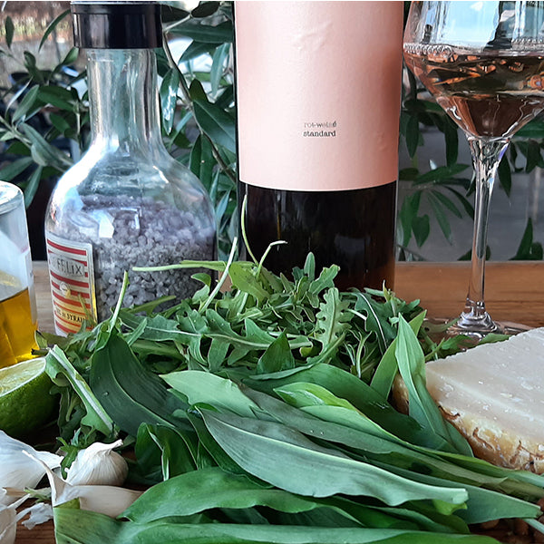 Eine Flasche Standard Rosé. Im Vorfeld Bärlauch, Rucola, Parmesan, Garlic und Salz.